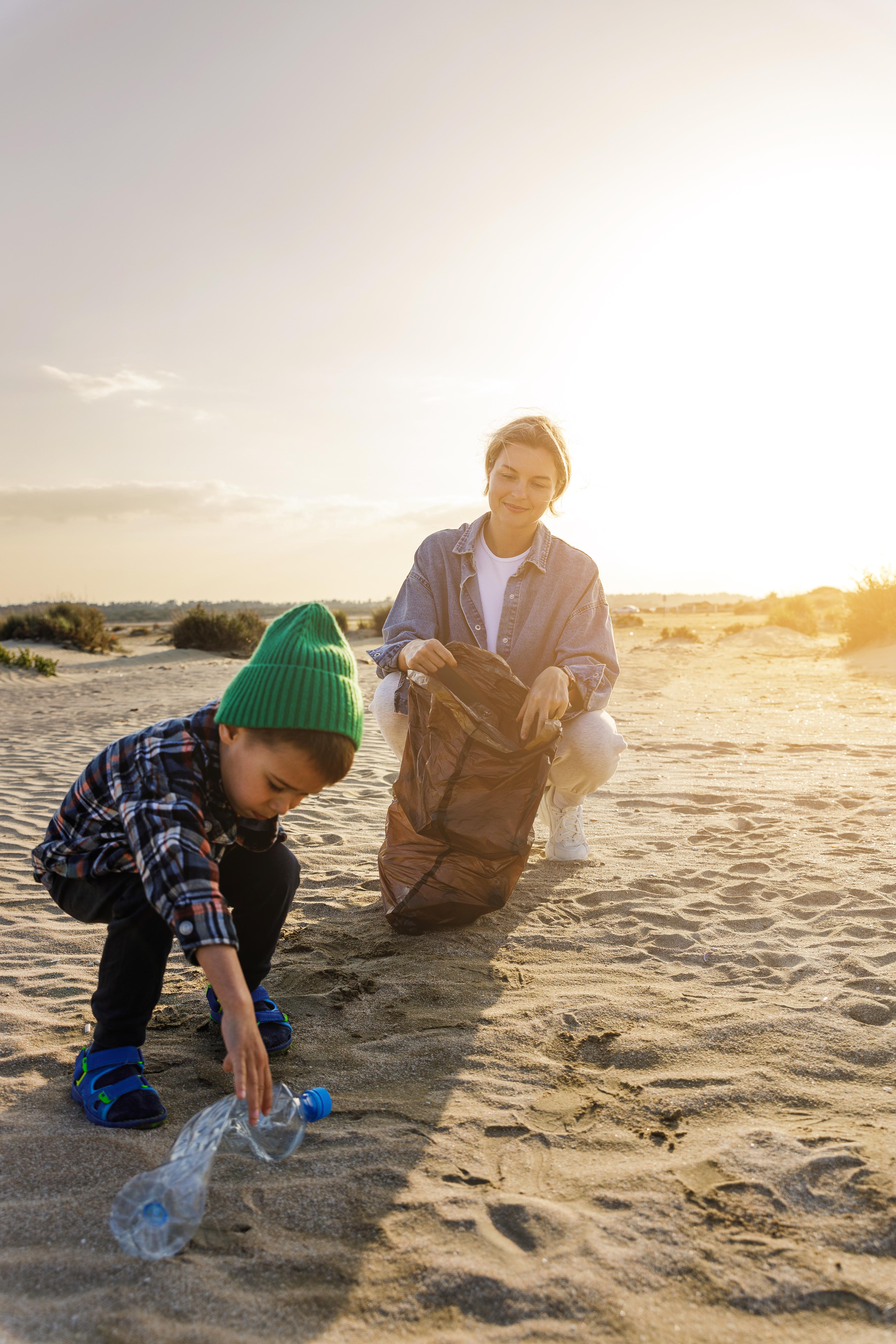 caucasian-family-is-collecting-plastic-waste-beach-mother-is-teaching-her-son-help-keep-nature-clean.jpeg