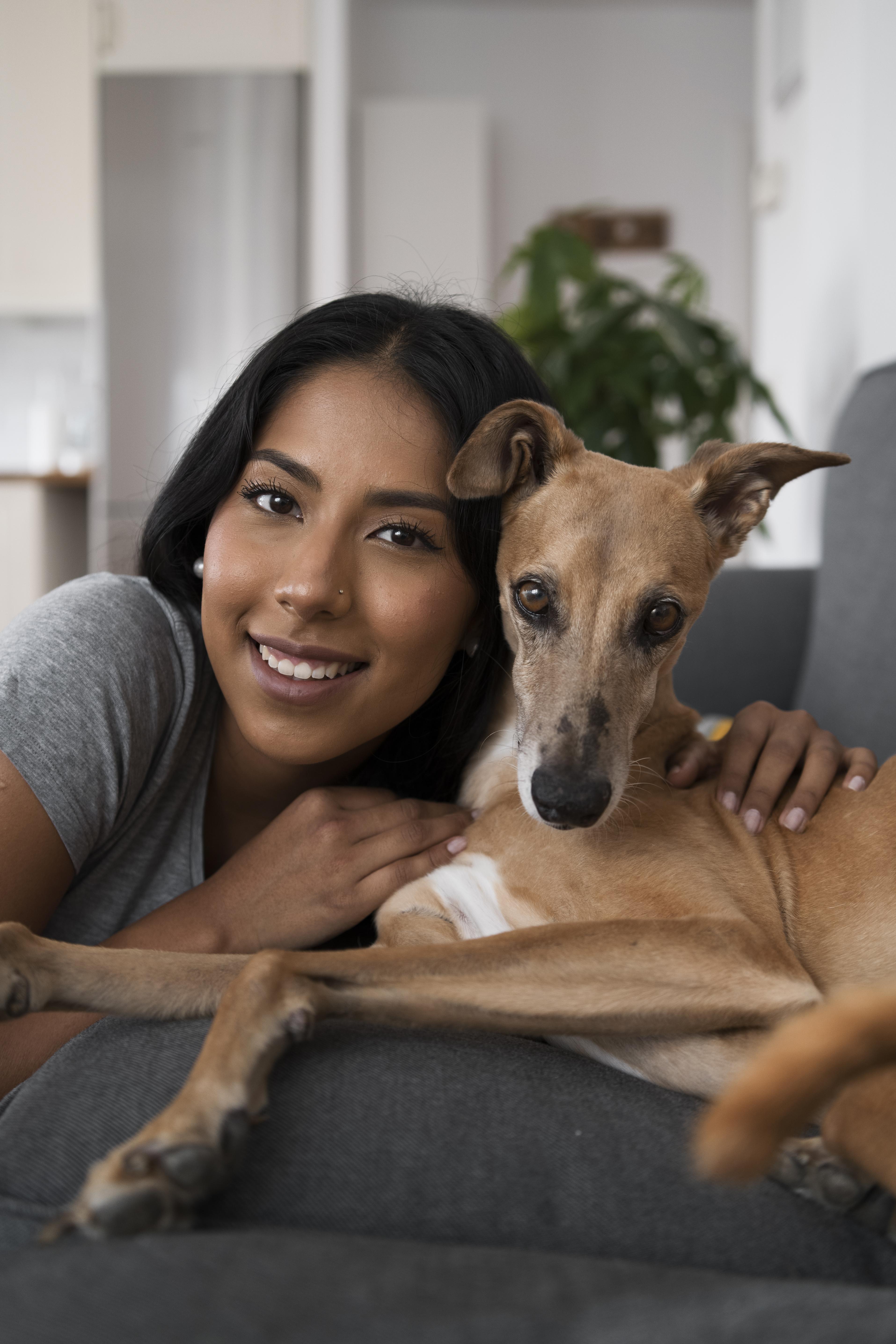 front-view-smiley-woman-holding-dog