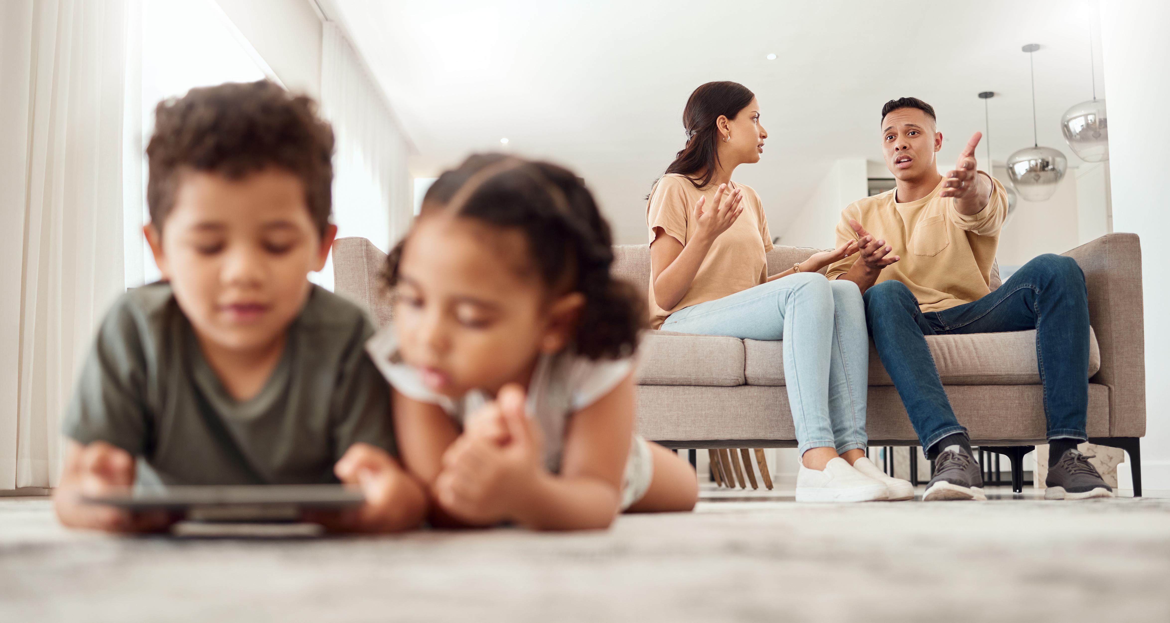 mother-father-disagreement-living-room-sofa-while-children-are-playing-with-tablet-floor-home-mama-dad-fighting-argue-conflict-difficult-situation-couch-dispute